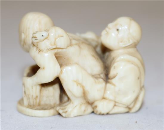 A Japanese ivory netsuke of a rat catcher and a boy, Meiji period, length 3.9cm